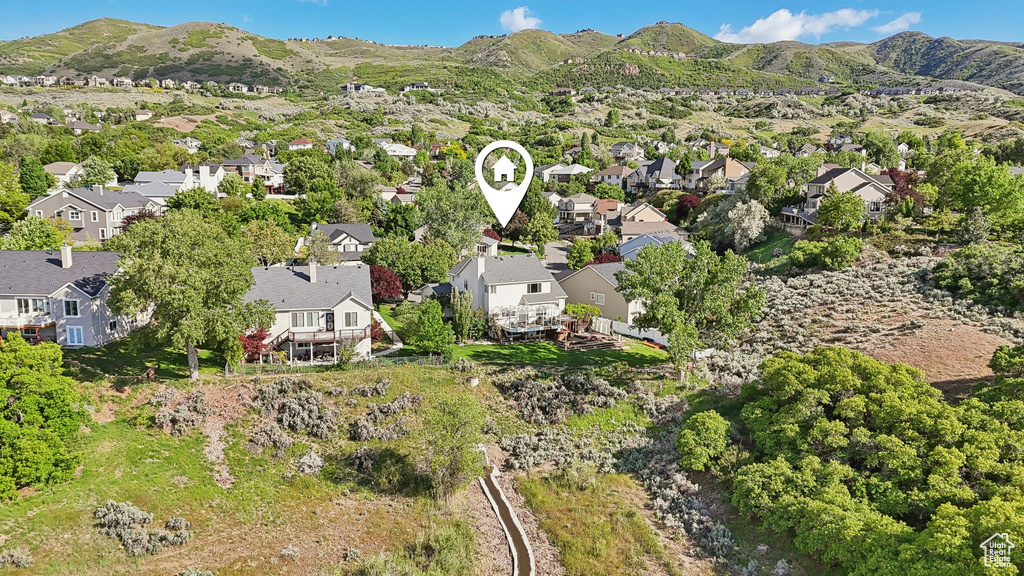 Aerial view of property\\\'s location with nearby suburban area and a mountainous background