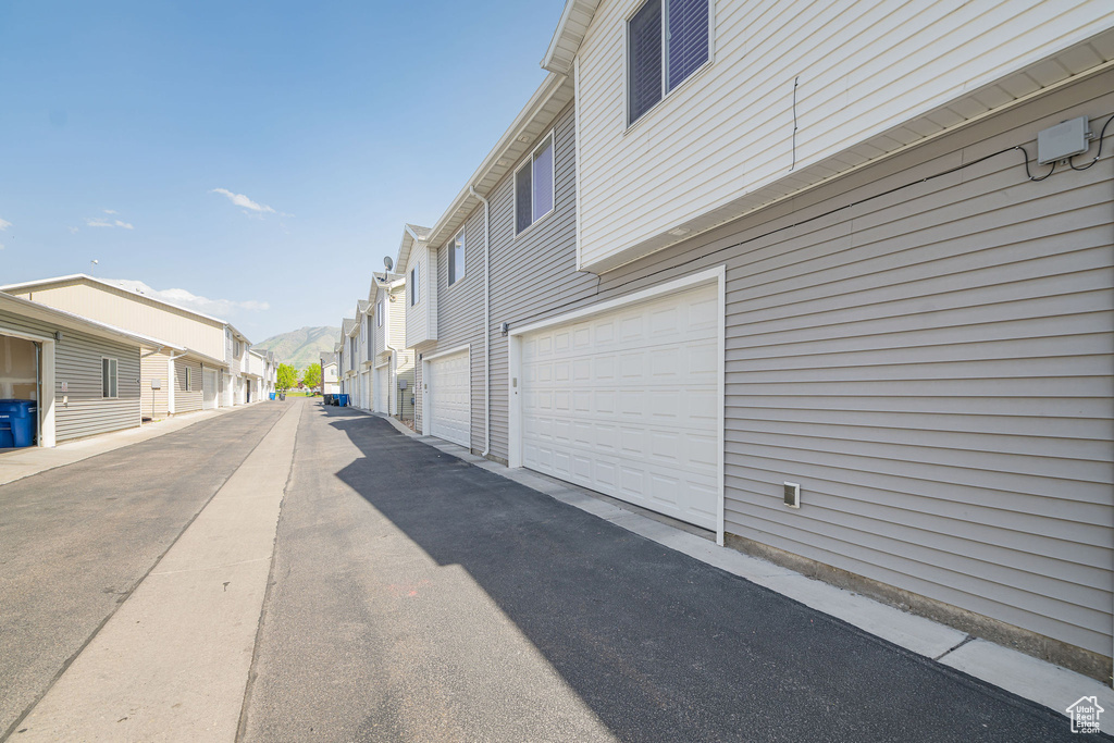 View of side of property featuring a residential view and a garage