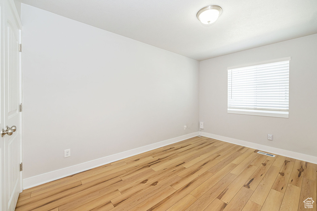 Empty room featuring wood finished floors and baseboards
