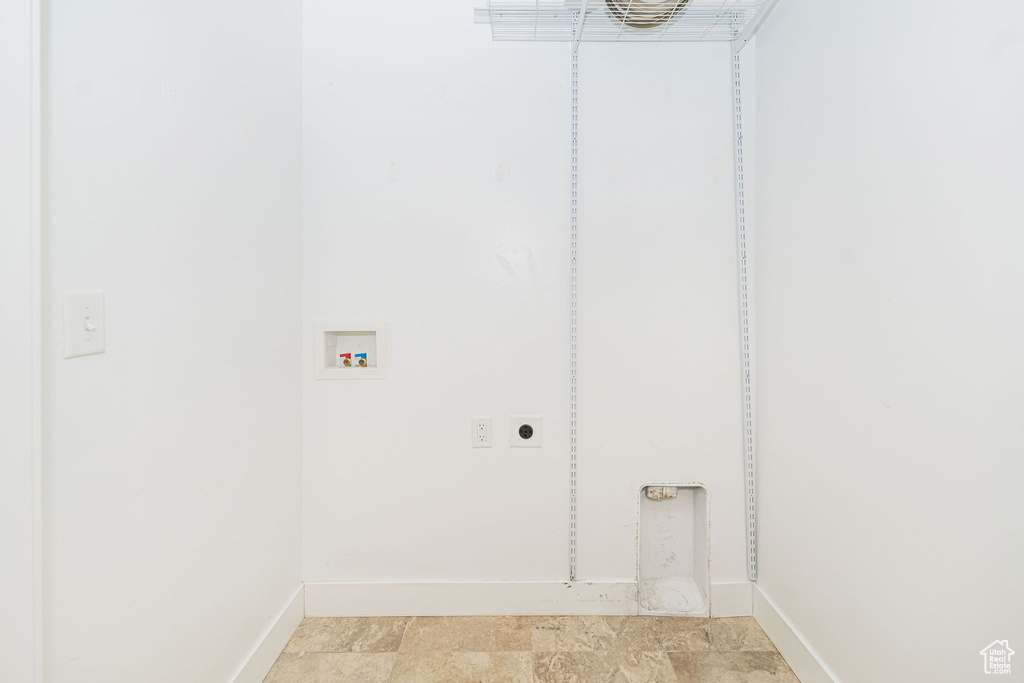 Laundry room featuring washer hookup, hookup for an electric dryer, baseboards, and light stone finish floors