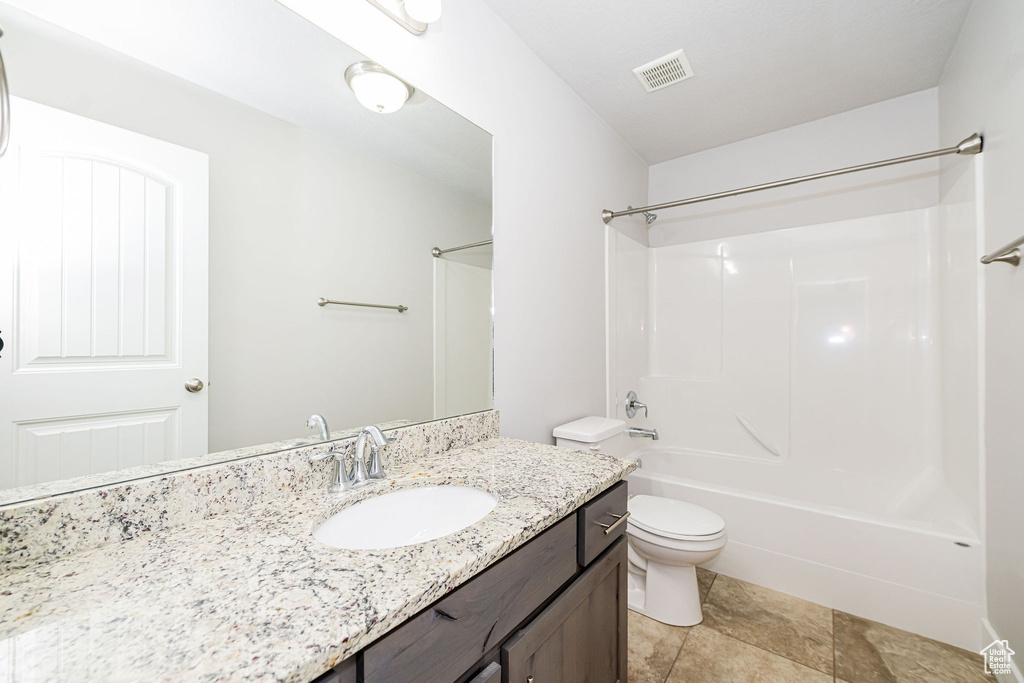 Full bath with toilet,  shower combination, and vanity