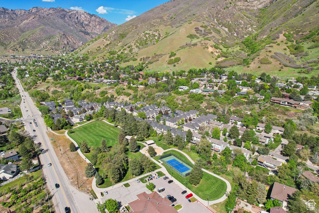 Aerial view of property\'s location featuring a mountainous background and nearby suburban area