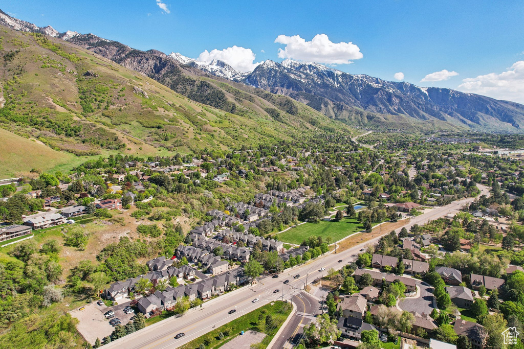 Aerial view of property\'s location with a mountain backdrop and nearby suburban area