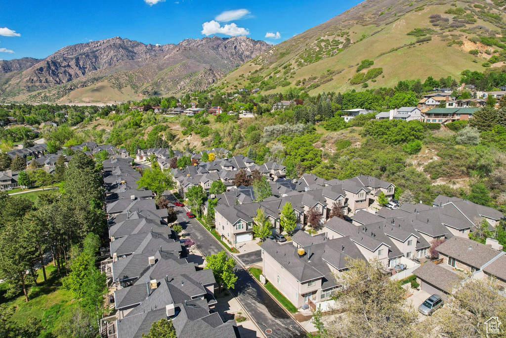 Aerial overview of property\'s location with nearby suburban area and a mountainous background
