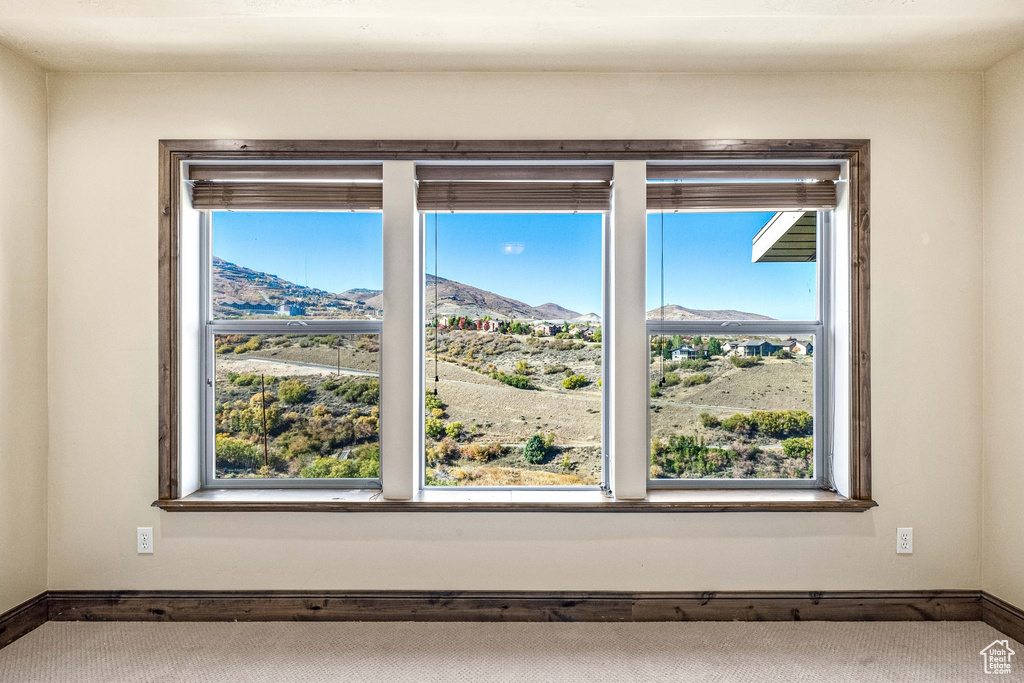 Detailed view of a mountain view, baseboards, and carpet floors
