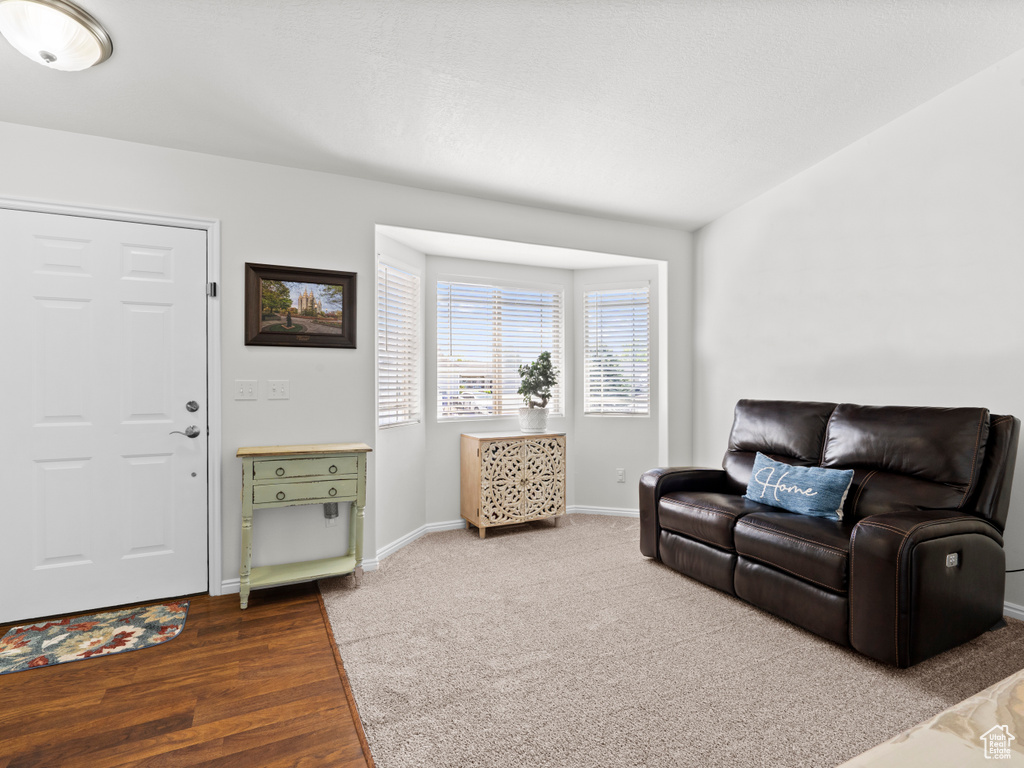 Living area with baseboards and wood finished floors