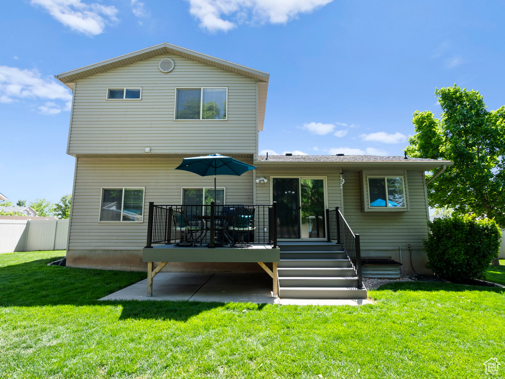 Rear view of house with a wooden deck