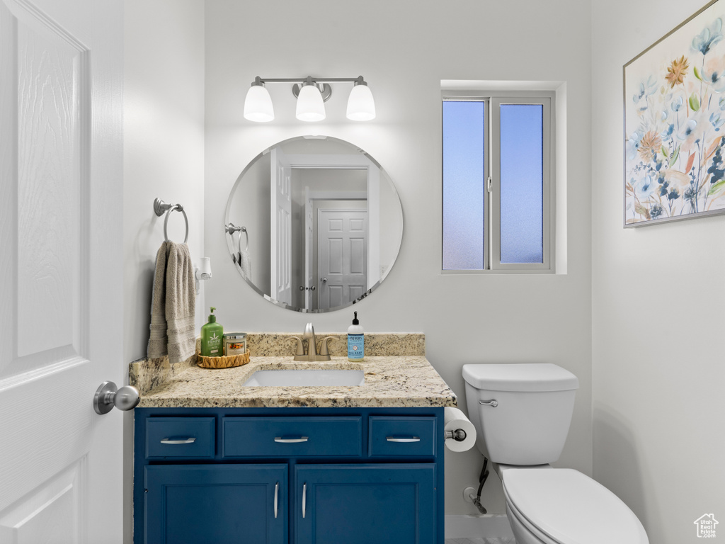Half bath featuring vanity and toilet