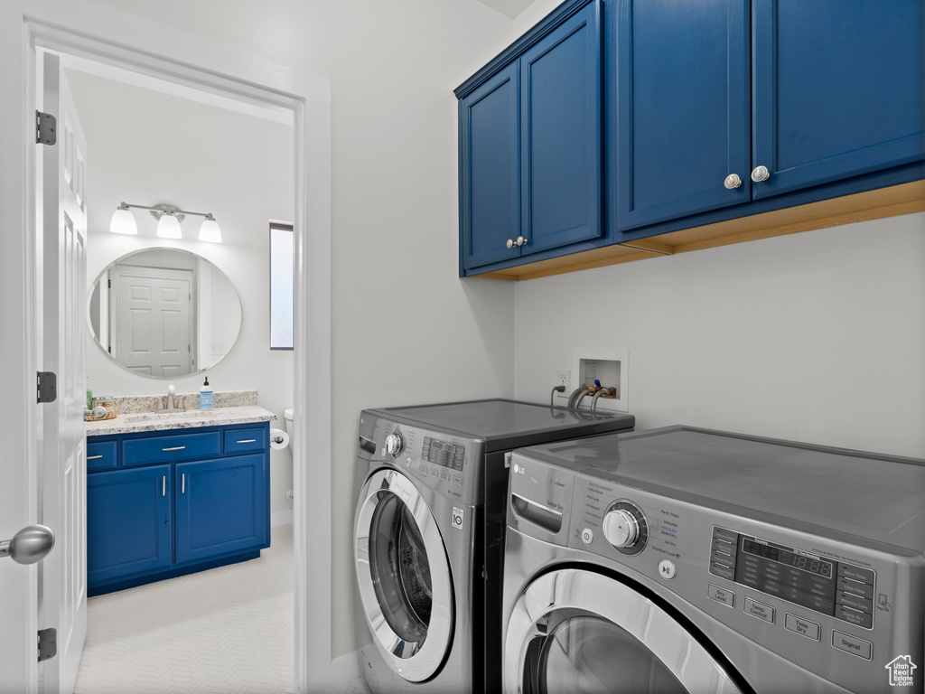 Laundry room featuring washing machine and clothes dryer and cabinet space