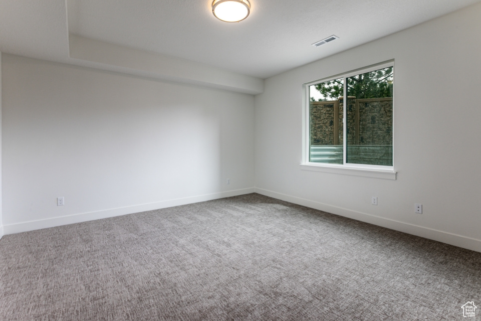 Unfurnished room with carpet and baseboards