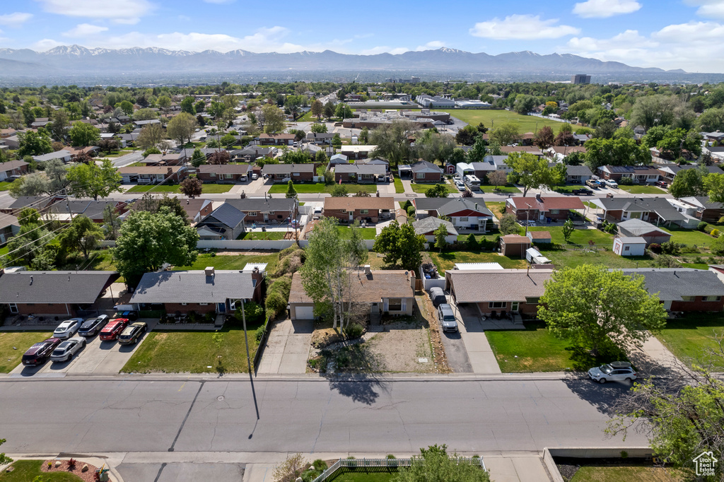 Aerial view of residential area featuring a mountainous background