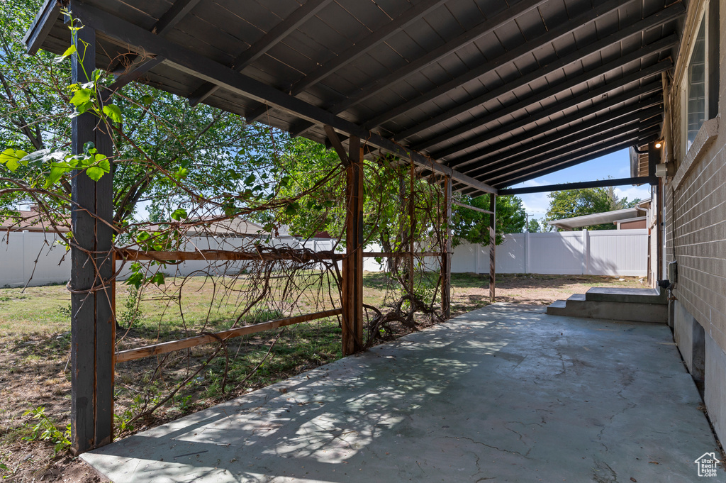 View of patio with a fenced backyard