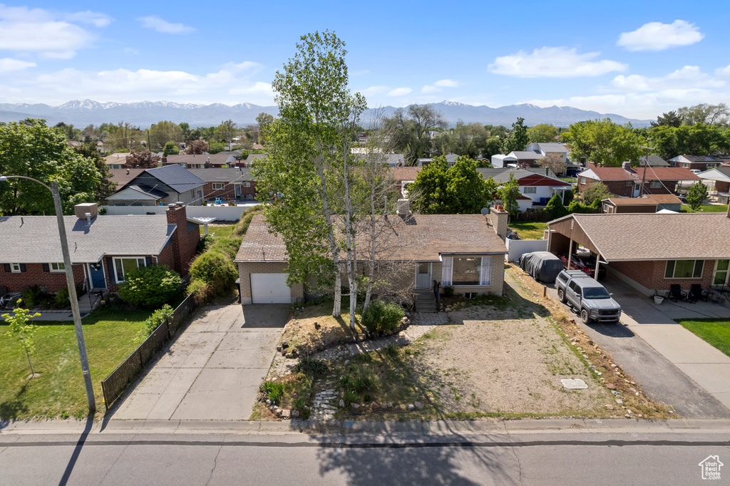 Aerial perspective of suburban area featuring a mountain backdrop