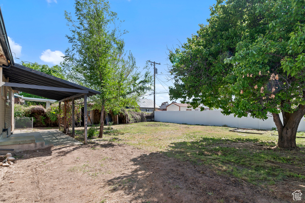 Fenced backyard with a patio area