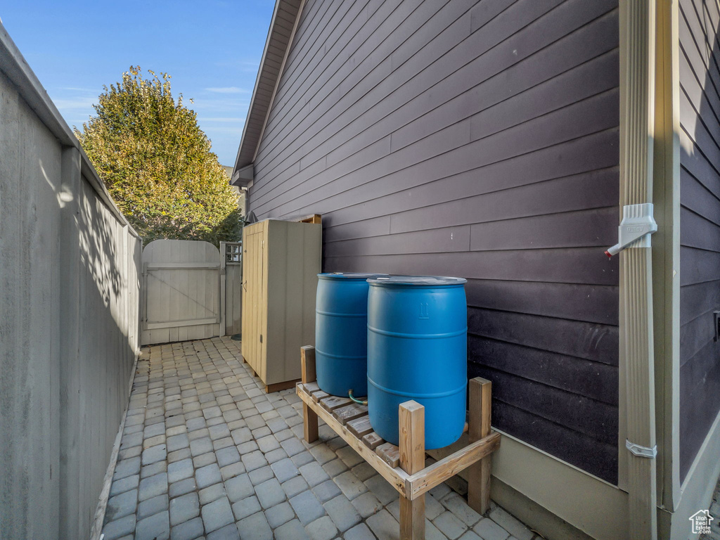 View of property exterior featuring a gate