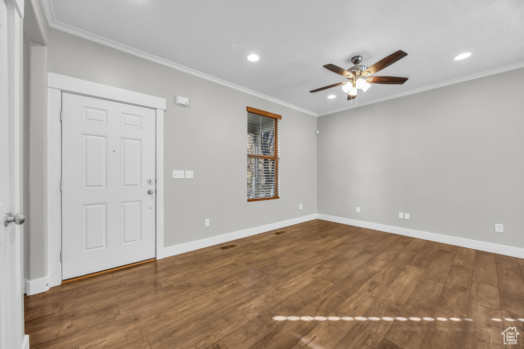 Unfurnished room featuring a ceiling fan, wood finished floors, recessed lighting, ornamental molding, and baseboards