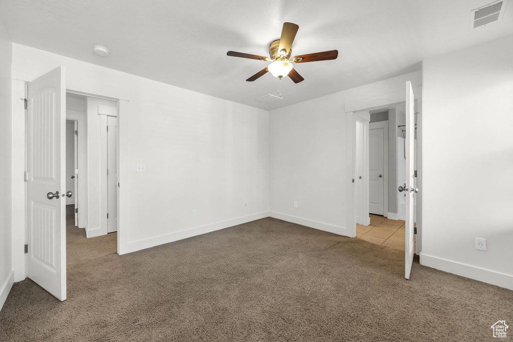 Unfurnished bedroom featuring carpet floors, baseboards, and ceiling fan