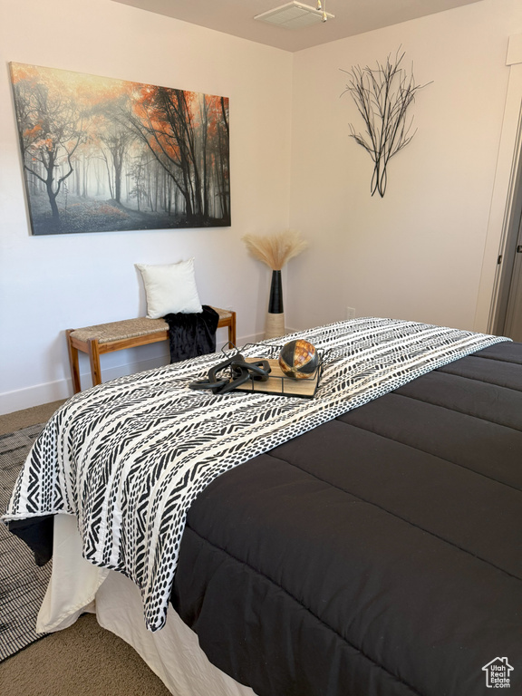 Bedroom featuring carpet flooring and baseboards