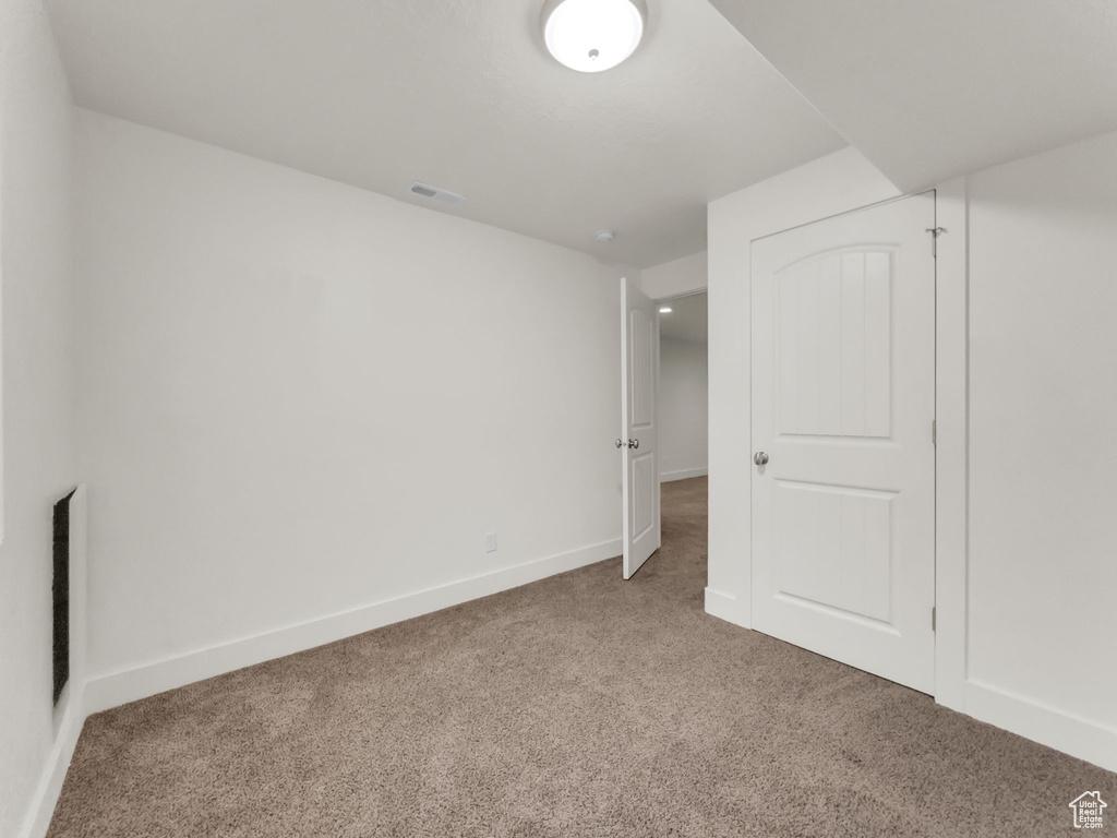 Unfurnished bedroom featuring carpet flooring and baseboards