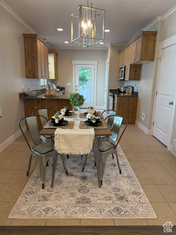 Dining area featuring light tile patterned floors, a chandelier, ornamental molding, recessed lighting, and baseboards