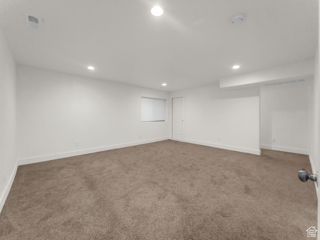 Finished below grade area featuring recessed lighting, carpet, and baseboards