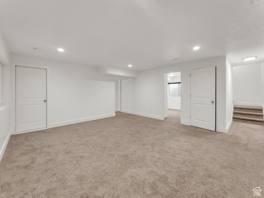 Basement with carpet, recessed lighting, baseboards, and stairs