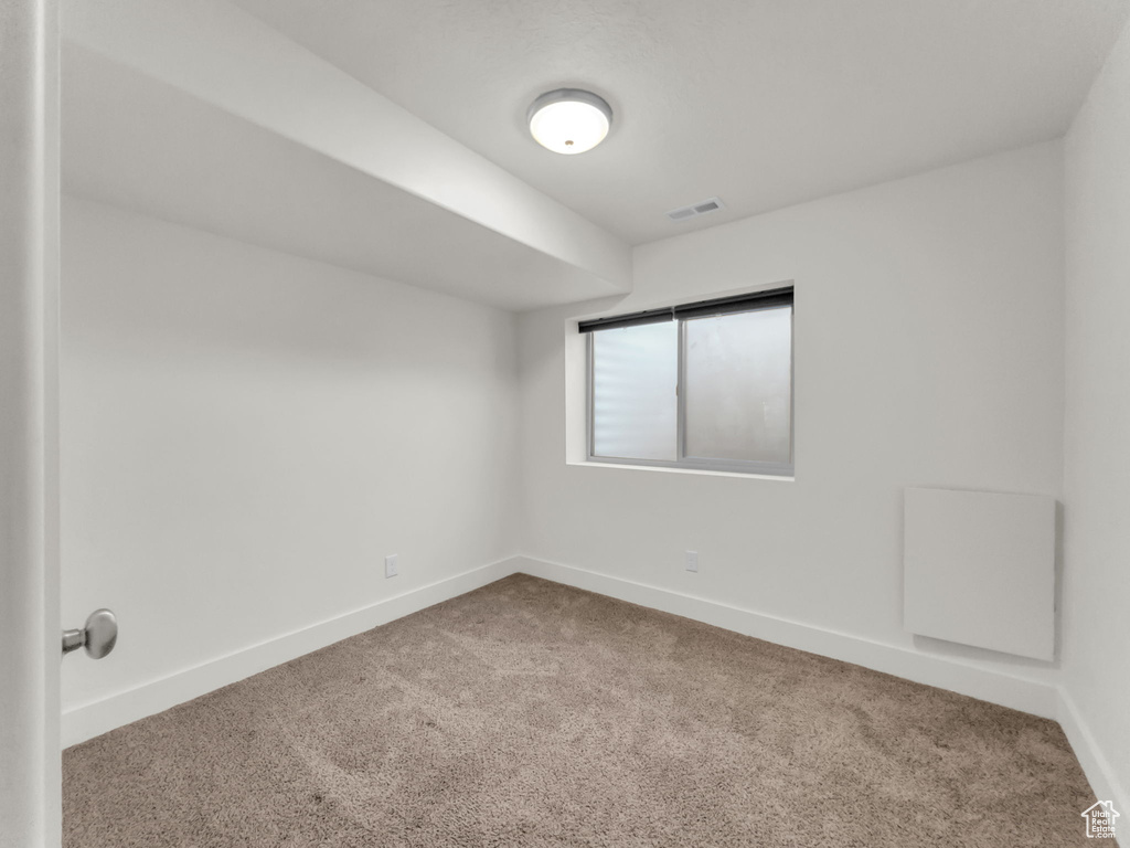 Empty room with carpet flooring and baseboards