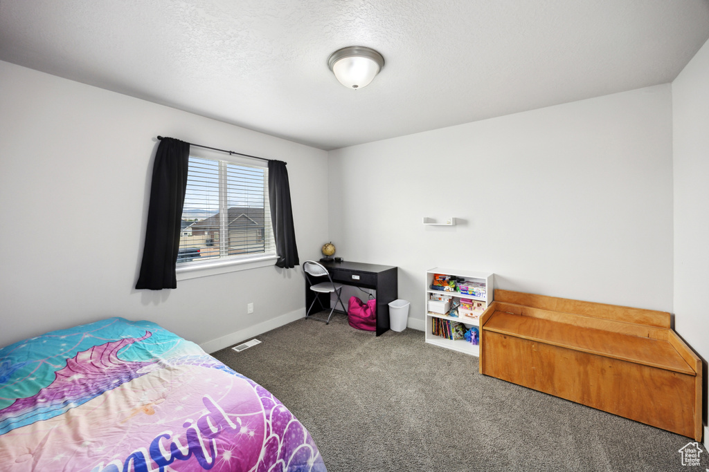 Carpeted bedroom featuring baseboards