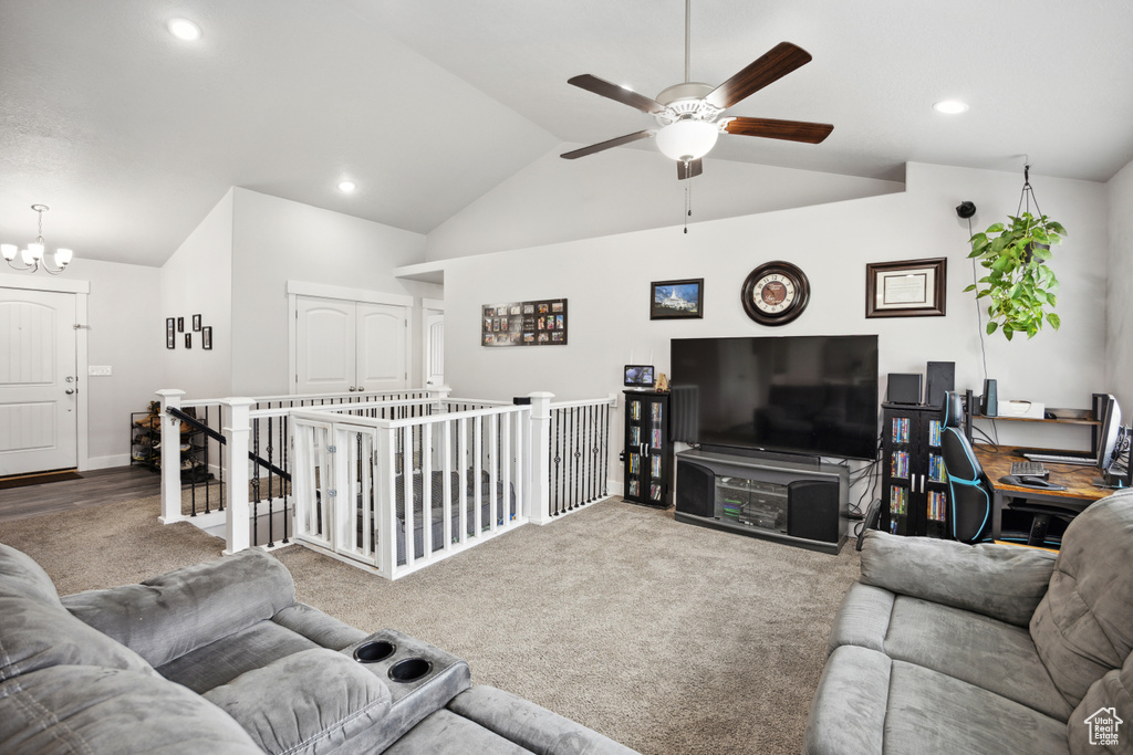 Carpeted living area featuring ceiling fan, vaulted ceiling, a chandelier, recessed lighting, and an office area