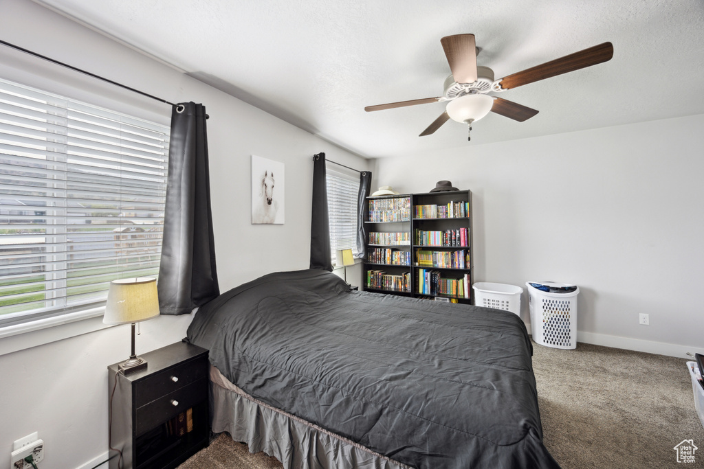 Bedroom with carpet flooring, a ceiling fan, and baseboards
