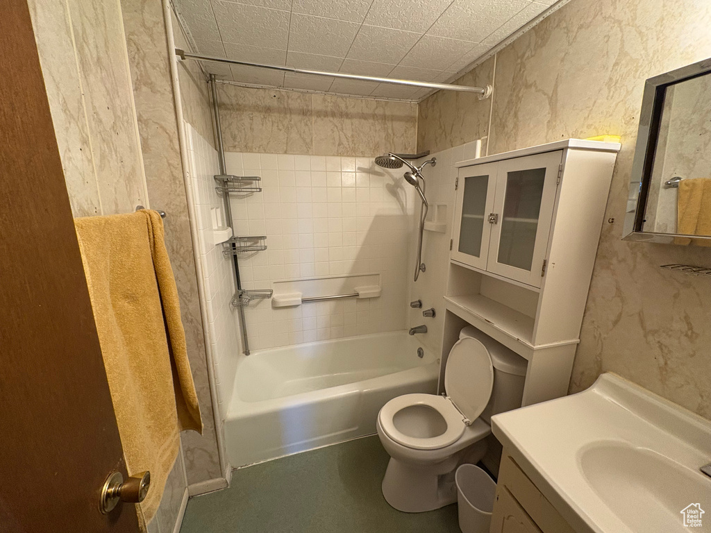 Bathroom with toilet, vanity, and shower / tub combination