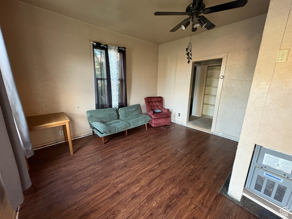 Living area with wood finished floors and ceiling fan