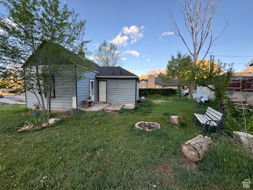 Rear view of property with a yard
