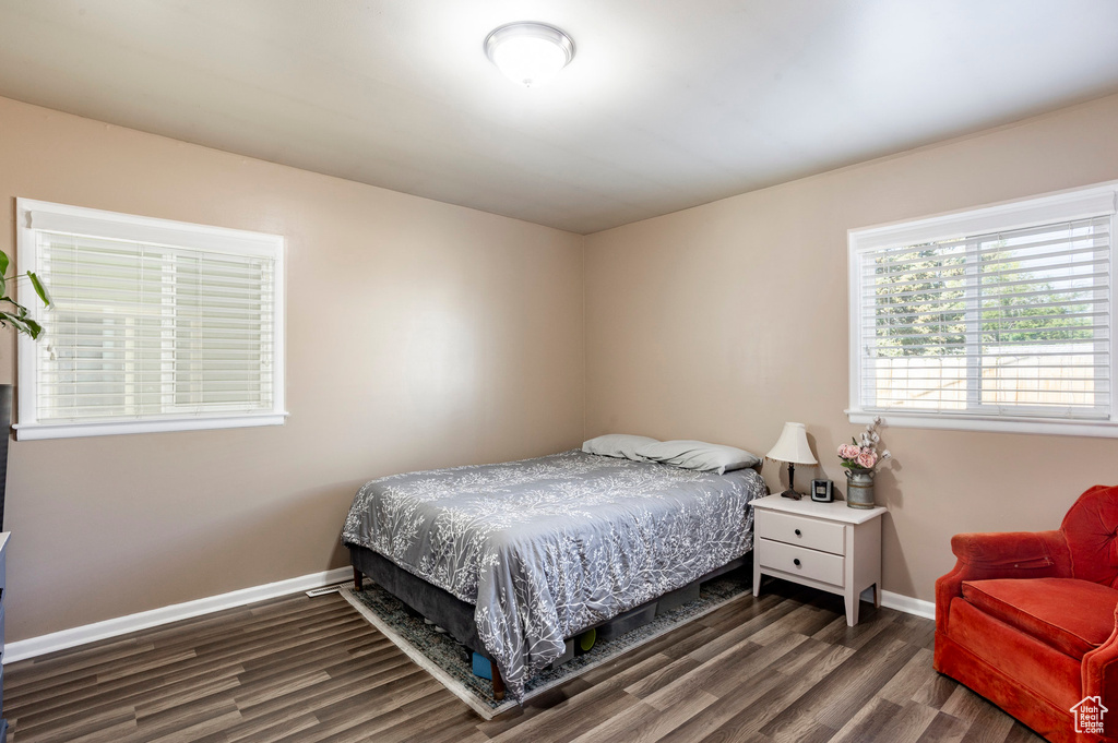 Bedroom featuring wood finished floors and baseboards