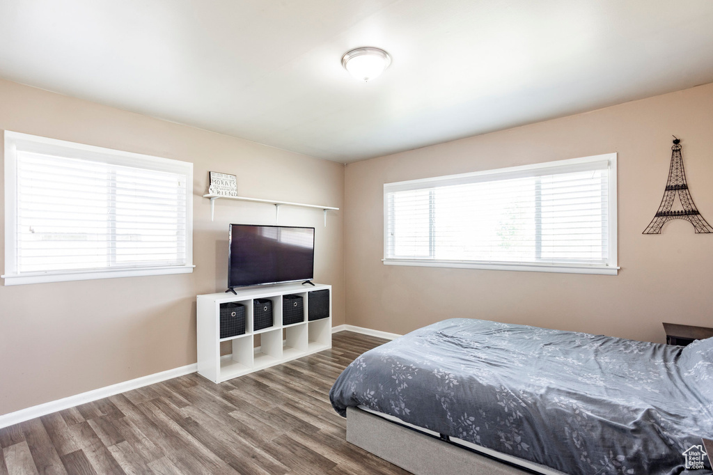 Bedroom with wood finished floors and baseboards