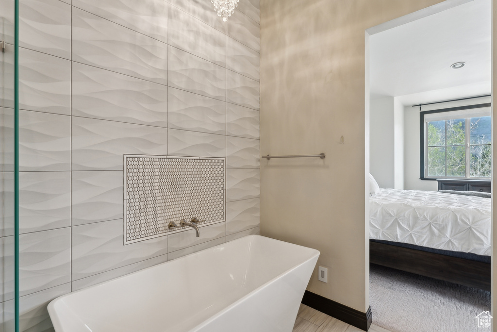 Ensuite bathroom featuring a soaking tub