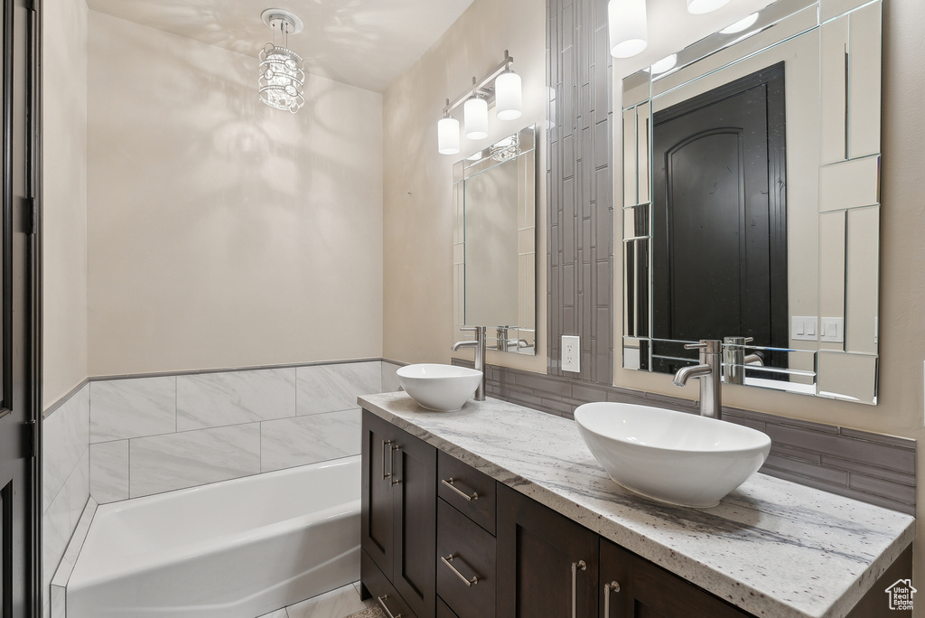 Full bath with a tub and double vanity