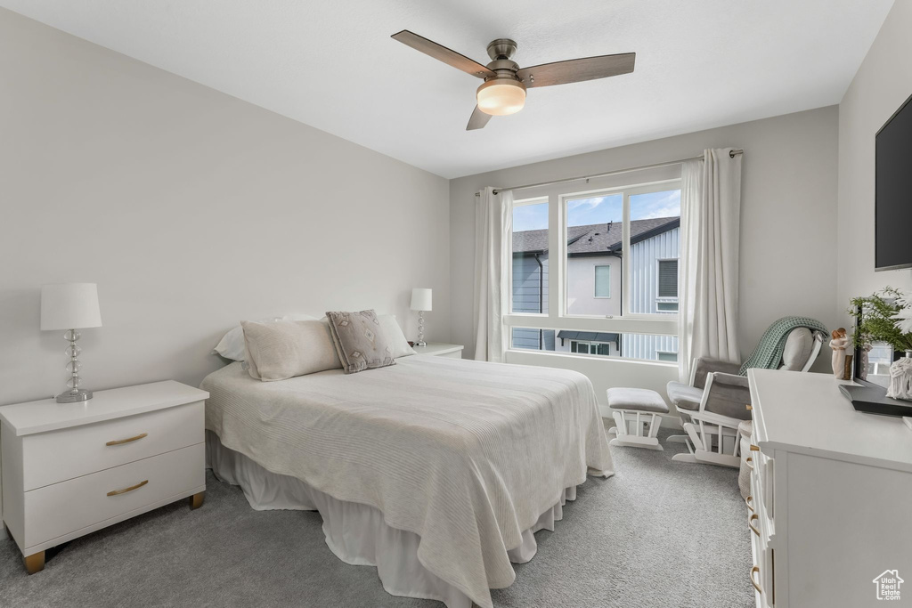 Bedroom with light colored carpet and ceiling fan