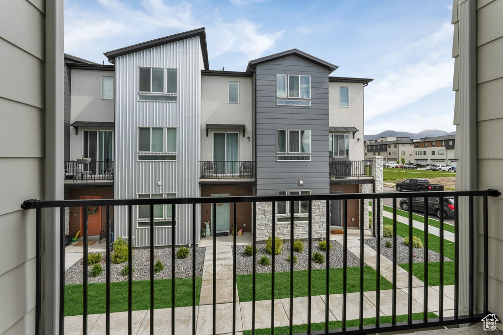 Back of property with a balcony and a residential view