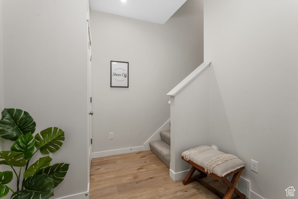 Stairway featuring baseboards and wood finished floors