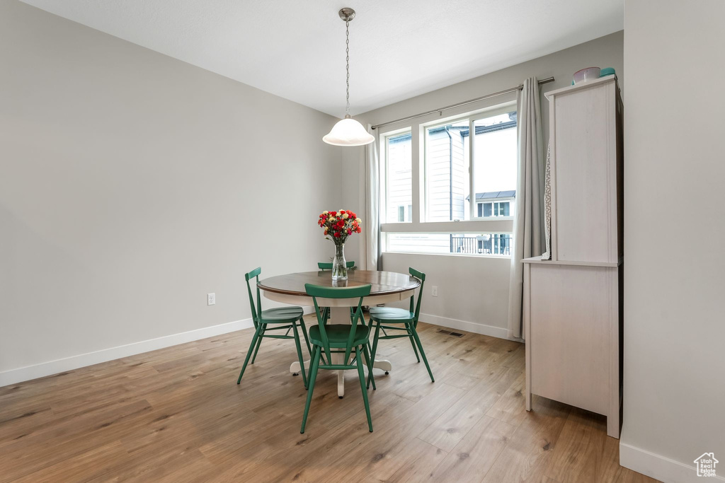 Dining space featuring light wood-style floors and baseboards
