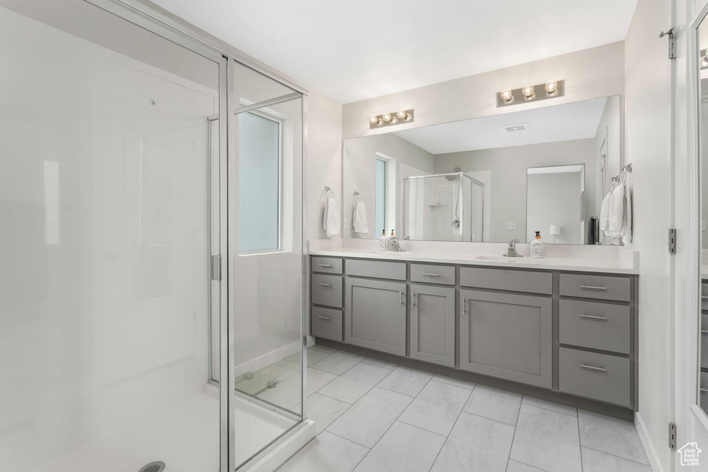 Bathroom with a stall shower and vanity