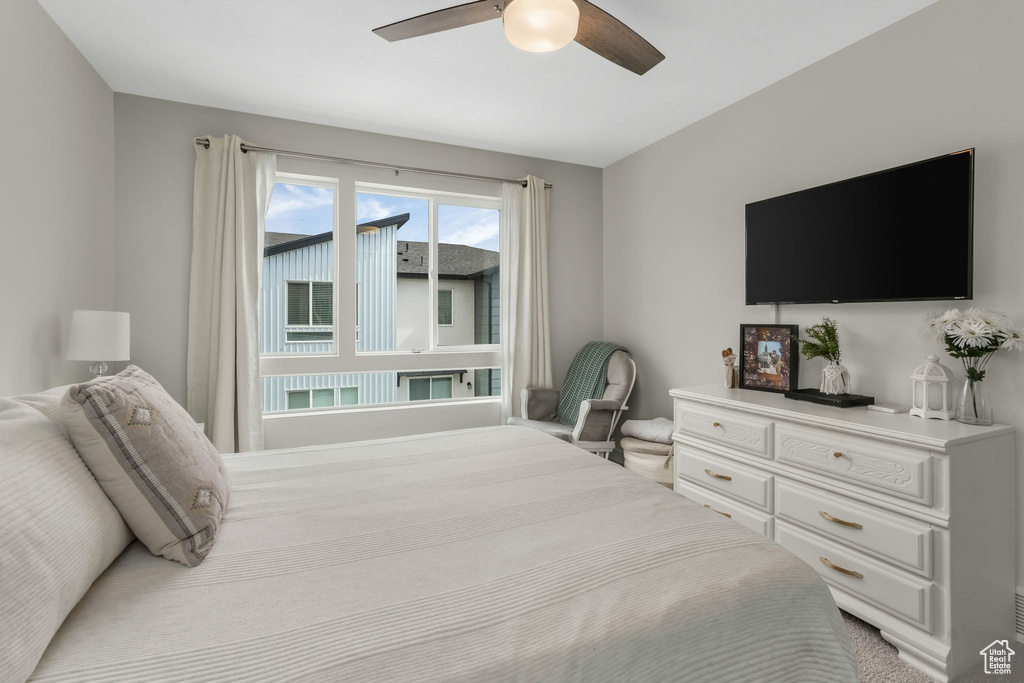 Bedroom featuring a ceiling fan and carpet