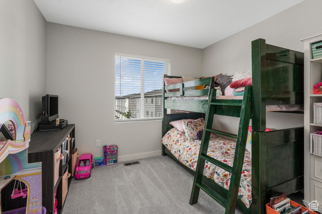 Bedroom featuring carpet floors and baseboards
