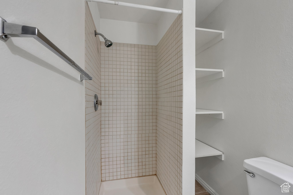 Bathroom featuring a stall shower and toilet