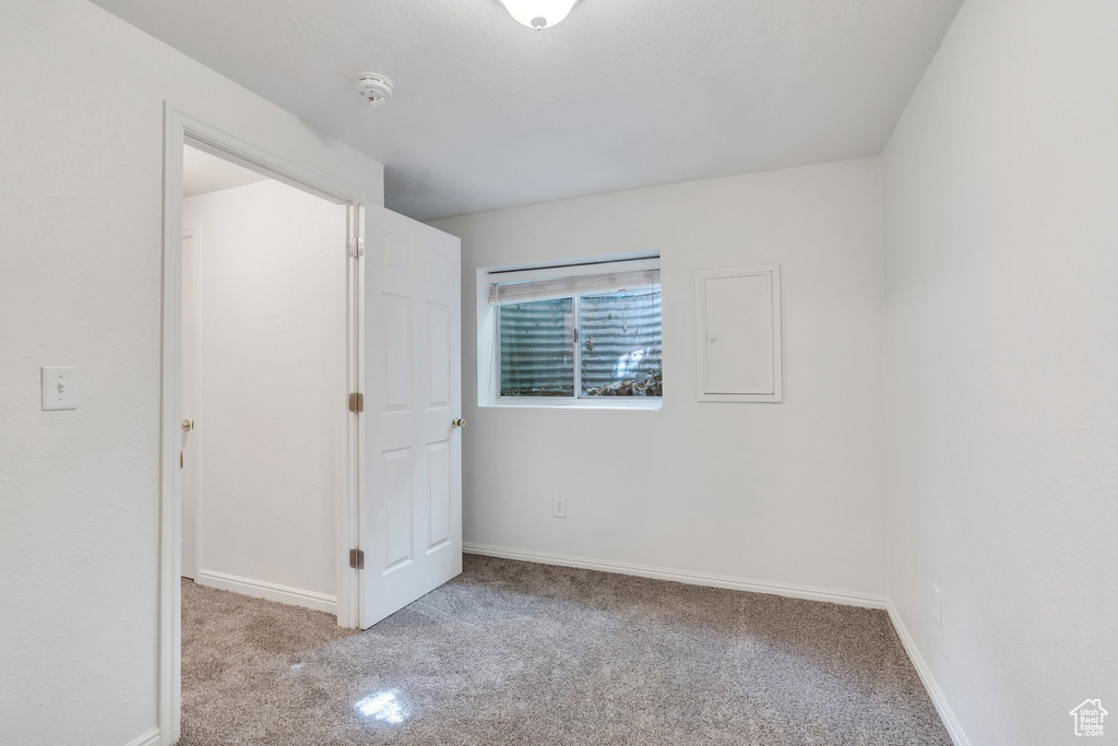 Unfurnished bedroom featuring carpet floors and baseboards