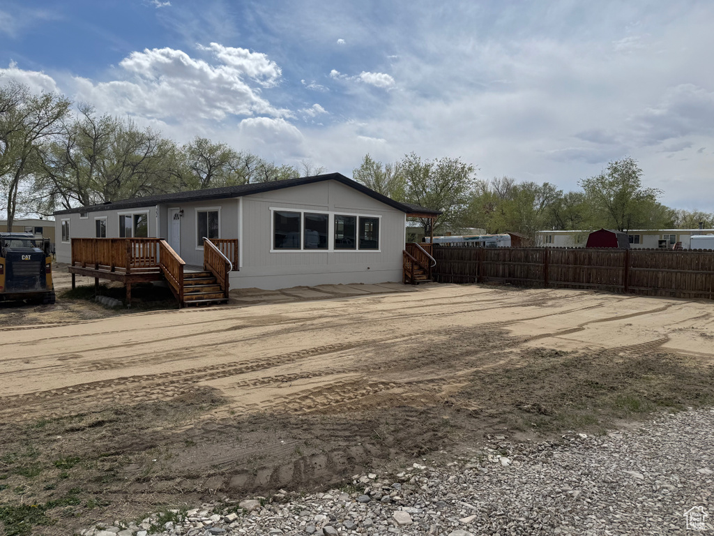 Rear view of property with fence and a wooden deck