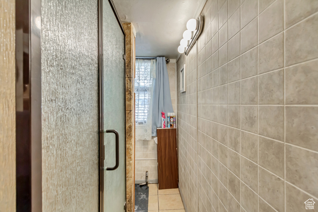 Hall with tile walls and tile patterned floors