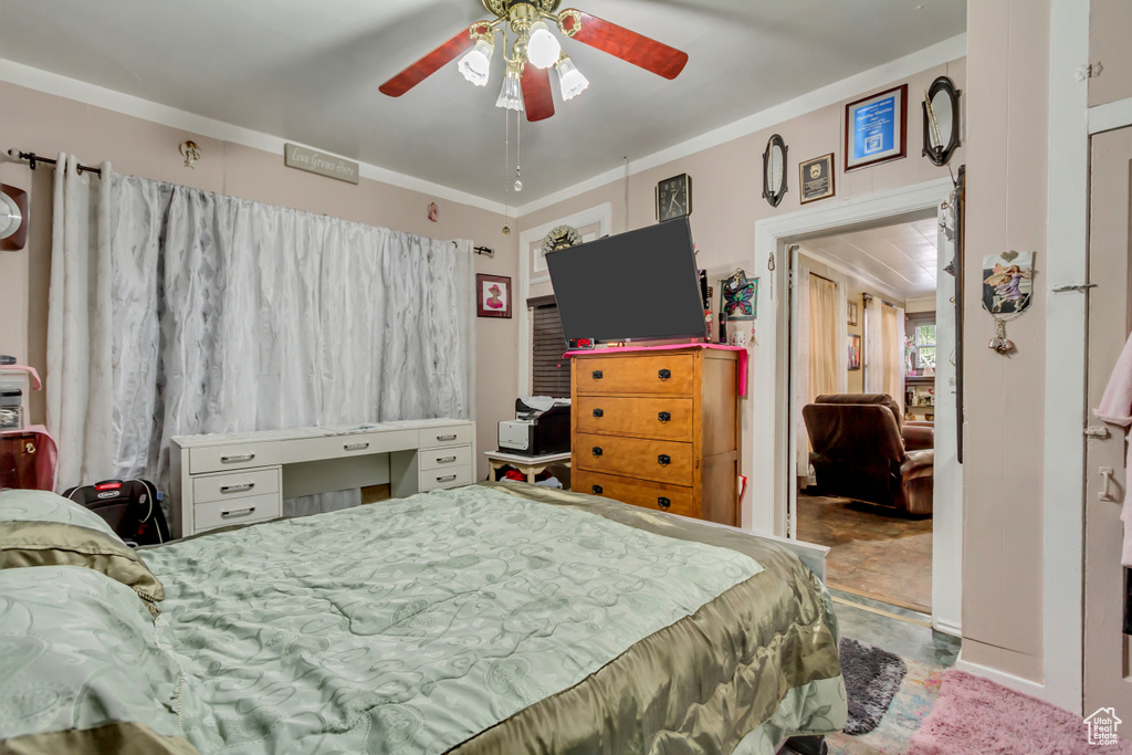 Bedroom with ornamental molding and ceiling fan