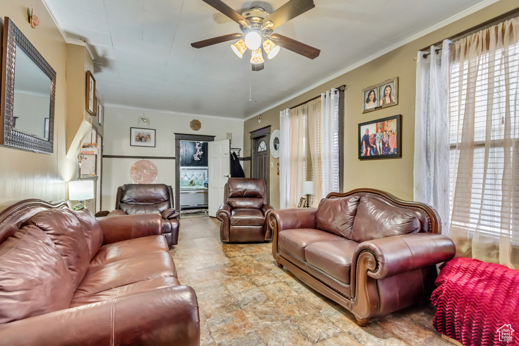 Living area featuring ceiling fan and ornamental molding